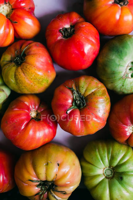 Hintergrund von frischen halbreifen grünen und roten Tomaten — Stockfoto