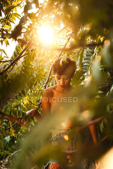 Attractive topless young female posing at garden — Stock Photo