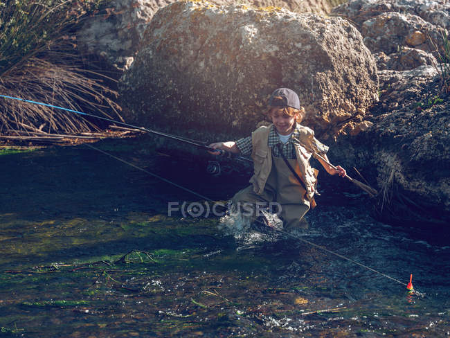 Young boy with rod — Stock Photo