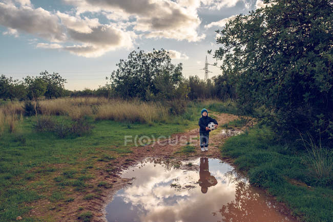 Boy with ball on field — Stock Photo