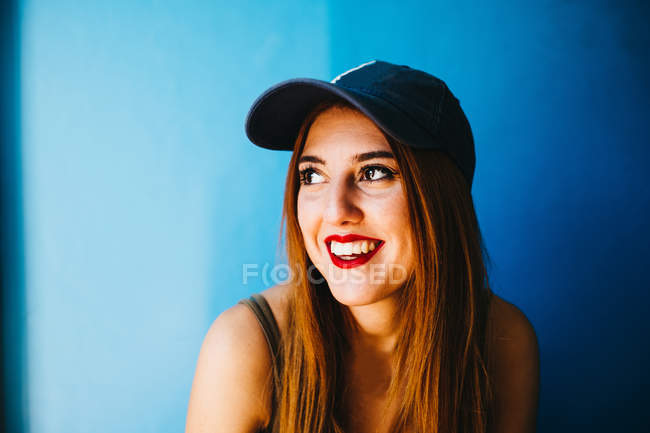 Smiling attractive woman in cap — Stock Photo