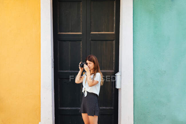 Jeune fille posant avec une caméra vintage — Photo de stock