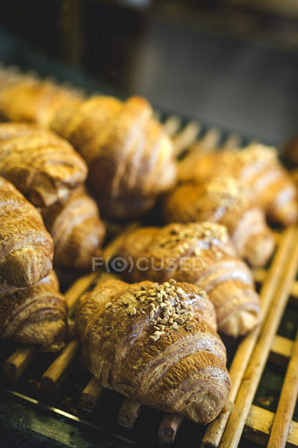 Freshly baked buns with almonds.Croissants an brioche.On dark background — Stock Photo