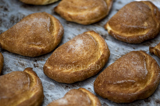 Croccanti panini al forno sul tavolo di legno — Foto stock