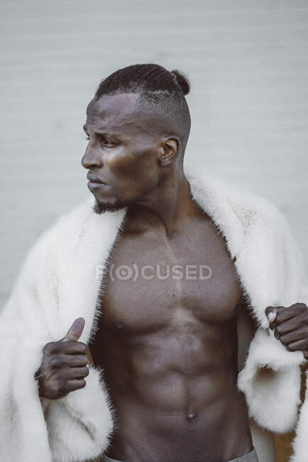 Stylish black man in fur coat — Stock Photo