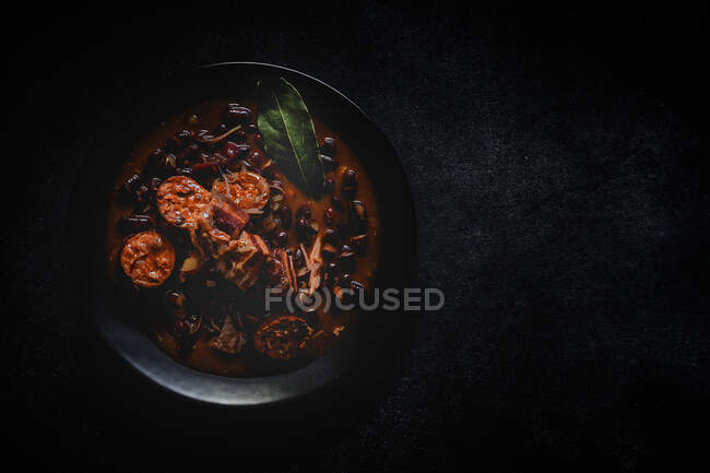 Red bean stew with Pork Meat. Homemade. Flat lay. Top view. Dark — Stock Photo