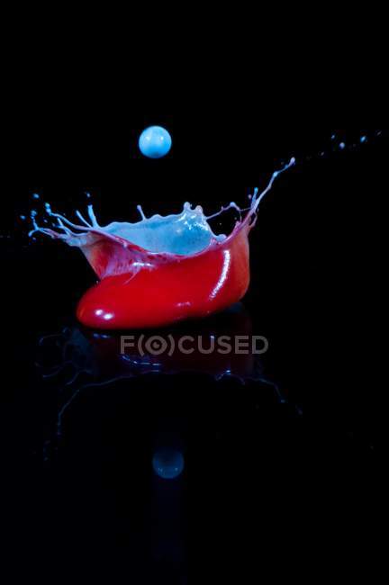 Closeup of splash of amazing mixed paint on black background — Stock Photo