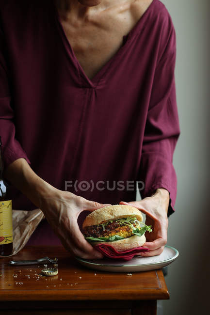 Primo piano di donna godendo di birra e hamburger vegetariano — Foto stock