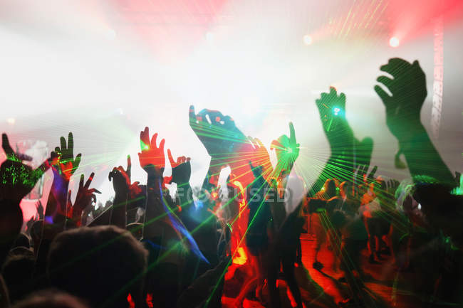 Unrecognizable people on illuminated dance floor — Stock Photo