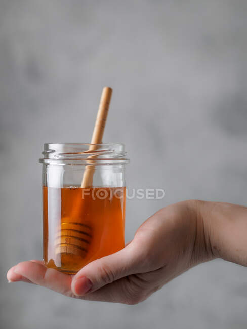 Crop female with jar of honey — Stock Photo