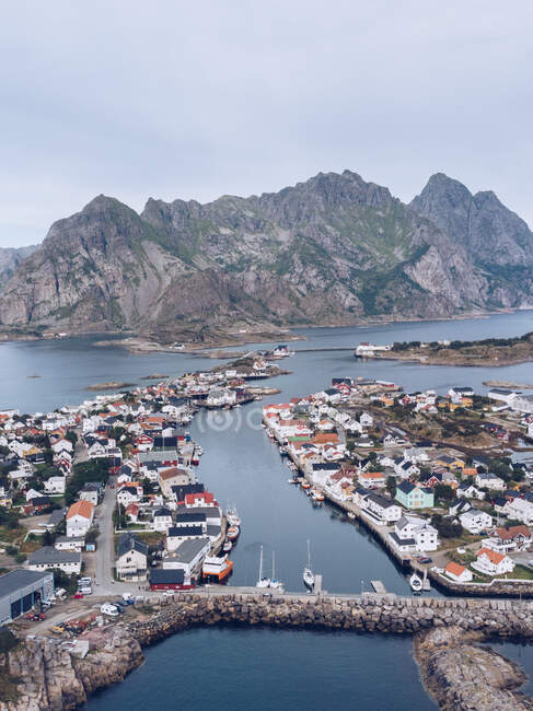 Aerial shot of town of Lofoten islands with beautiful rocky mountains on seashore, Norway — Stock Photo