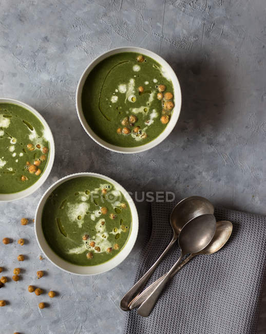Bowls with spinach, kale and fennel cream soup on grey surface — Stock Photo