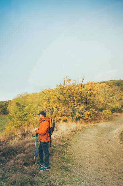 Hiker man on a trail in autumn colors — Stock Photo