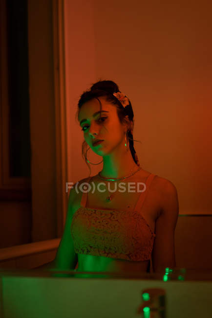 Reflection of sensual young lady in bathroom mirror in redness — Stock Photo