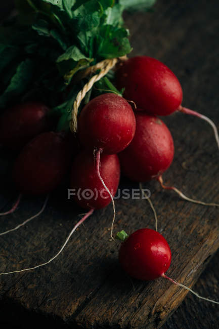 Bunch of fresh radishes on wooden background — Stock Photo