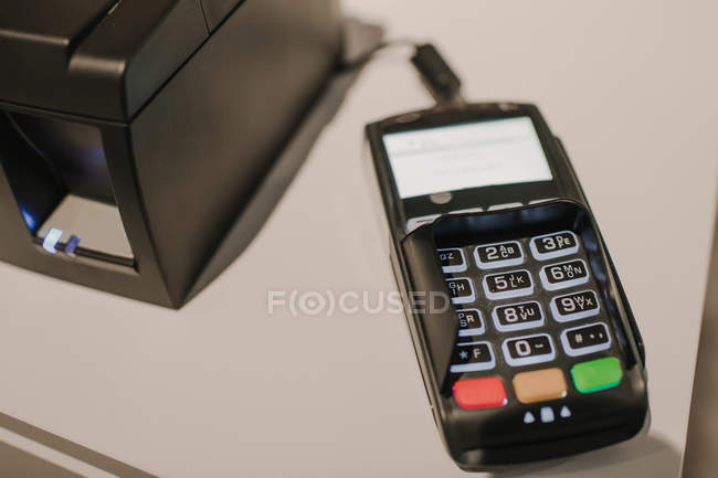 Closeup shot of modern payment terminal lying on counter in modern store — Stock Photo