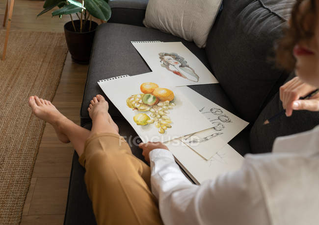Woman with draws on papers — Stock Photo