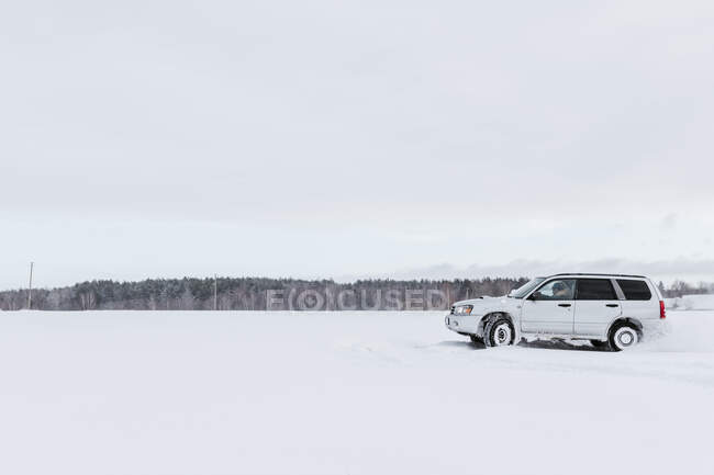 Car driving on snow field — Stock Photo