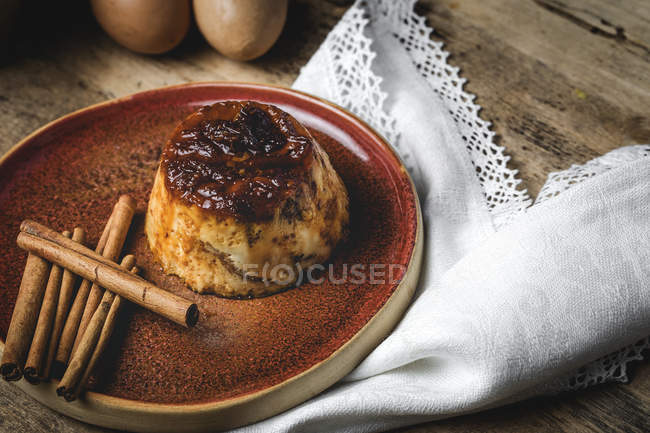 Delicious homemade pudding on plate on rustic wood table — Stock Photo