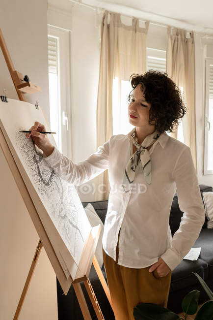 Person drawing city on canvas — Stock Photo
