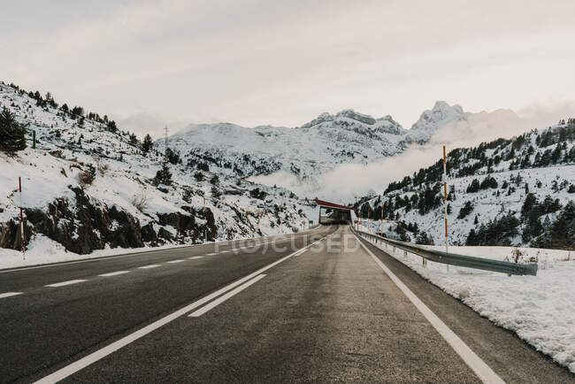 Snowy route running between mountains in Pyrenees — Stock Photo