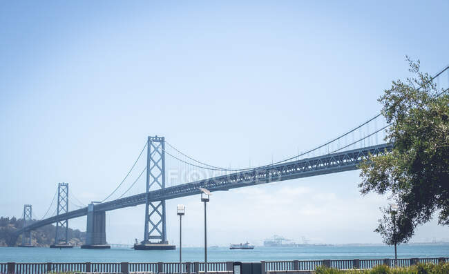 Bridge above water near coast in sunny day — Stock Photo