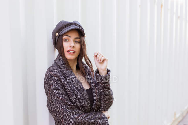 Thoughtful stylish Hispanic lady leaning on wall — Stock Photo