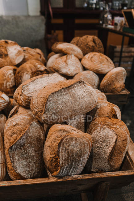 Fresh loaves of rye bread on trays — Stock Photo