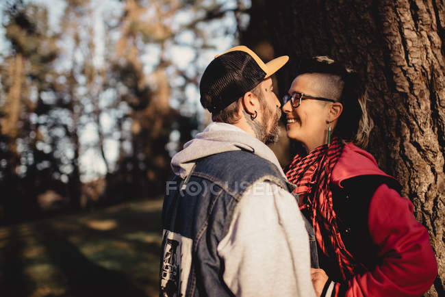 Happy couple kissing on sunny weather — Stock Photo