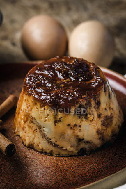 Close-up of delicious homemade pudding on plate on rustic wood table — Stock Photo