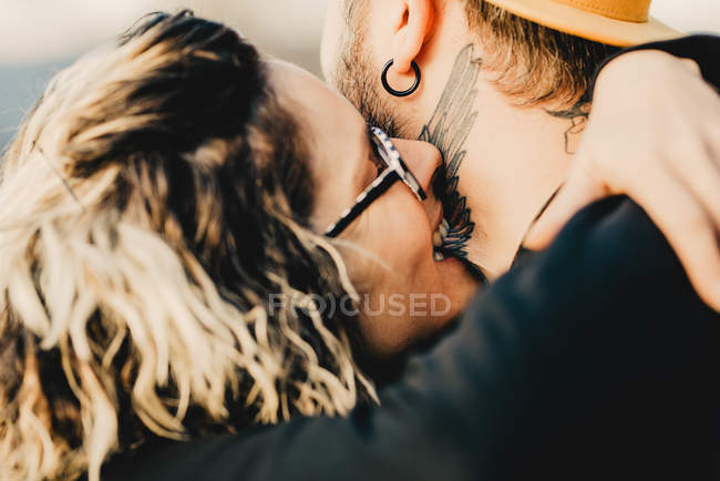 Girlfriend biting boyfriend neck in forest — Stock Photo