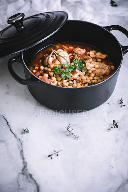 Stew pot of freshly made vigil potaje dish placed on white marble counter — Stock Photo