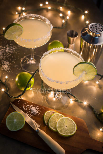 Bicchieri di cocktail margarita su tavolo illuminato con ingrediente — Foto stock