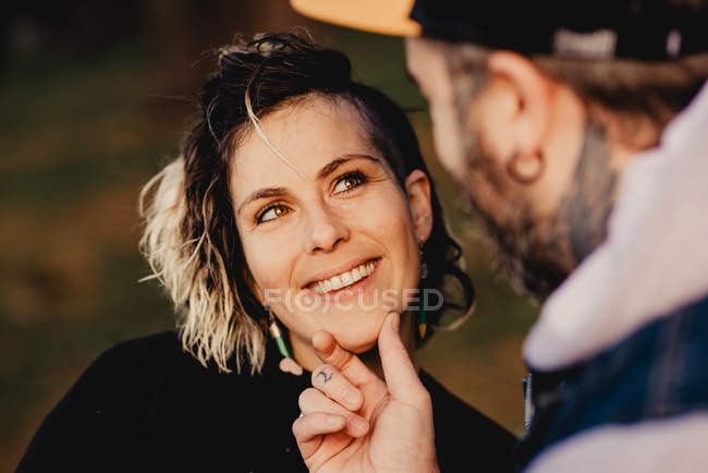 Happy couple looking at each other on sunny weather — Stock Photo