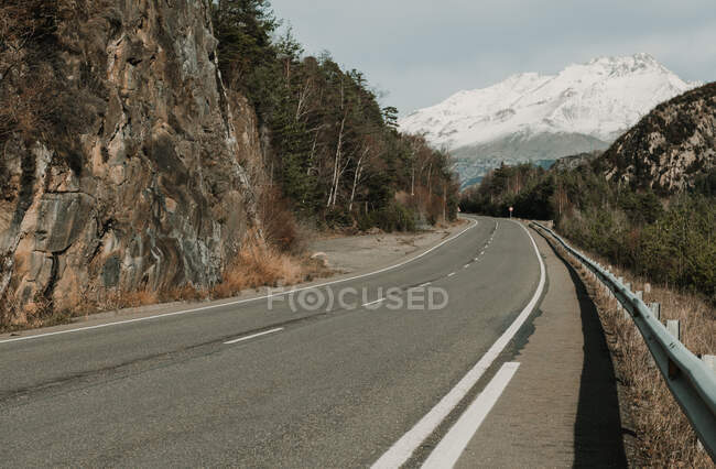 Countryside route on valley with woods and wonderful snowy mountains in Pyrenees — Stock Photo