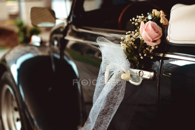 Flower on handle of retro car — Stock Photo