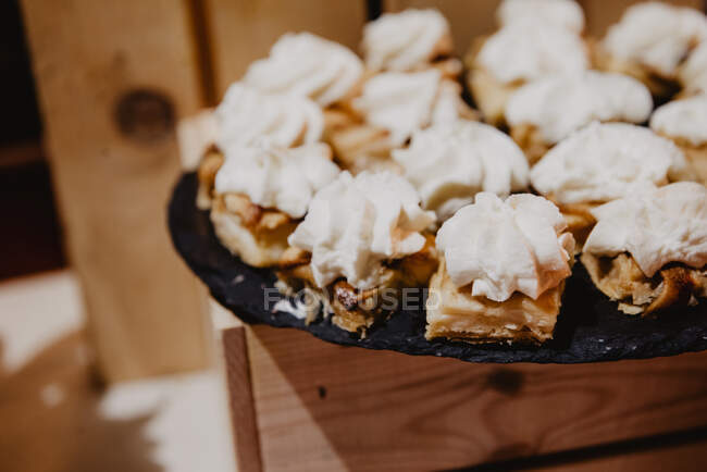 Closeup set of delicious baked cookies on dish on wooden stand — Stock Photo
