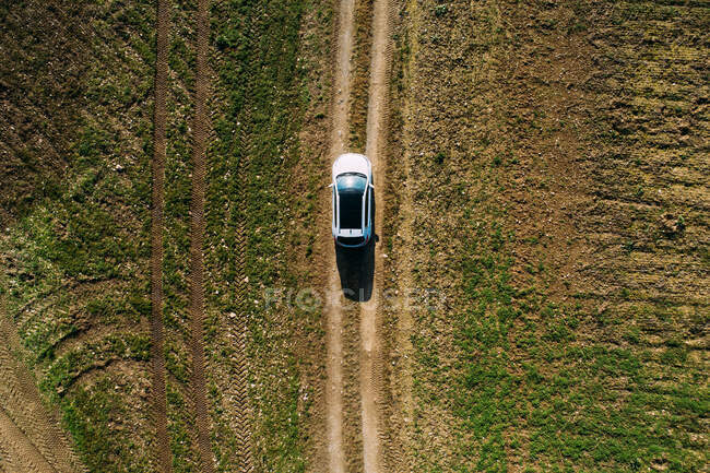 Aerial view of a car crossing a dirt road — Stock Photo