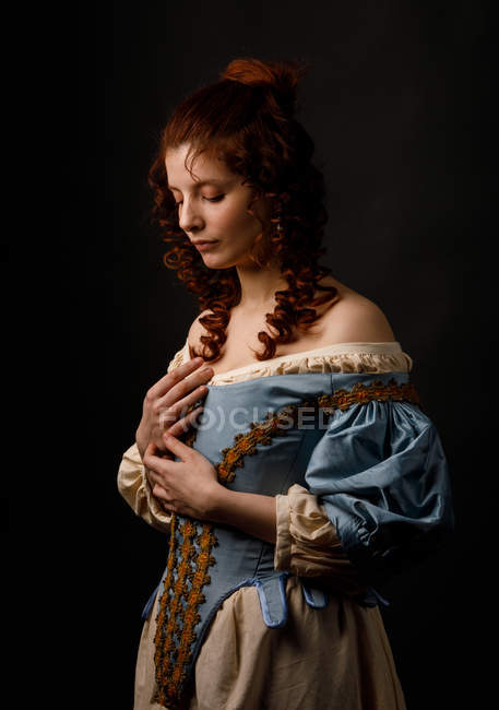 Beautiful woman posing in medieval clothing. — Stock Photo