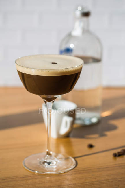 Espresso martini cocktail served in glass on table — Stock Photo