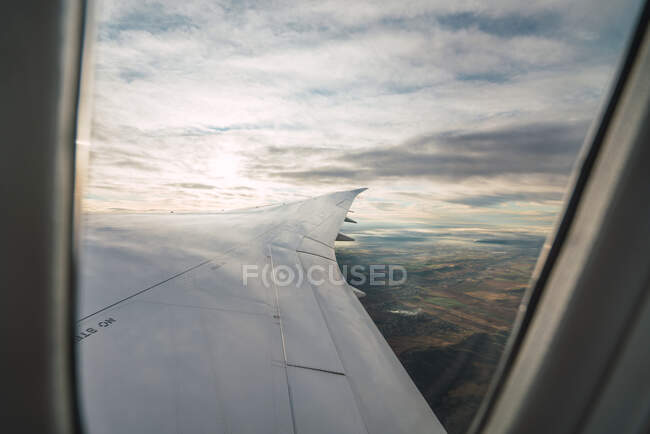 Bearded passenger using device in aircraft — Stock Photo