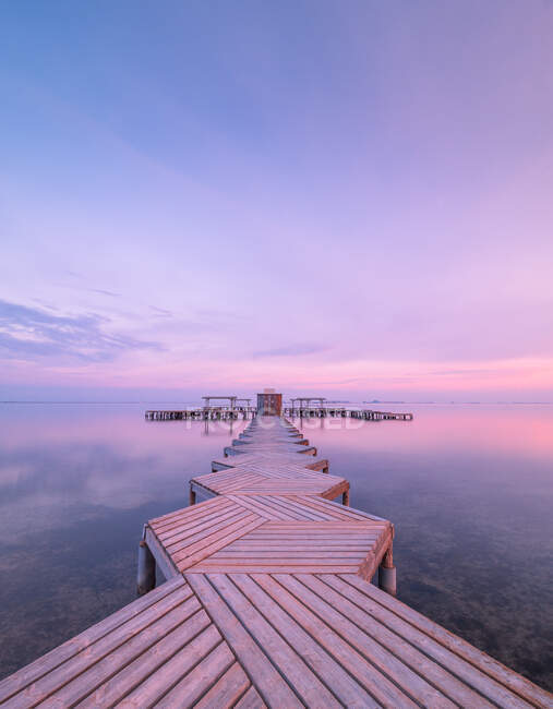 Wooden pier on cloudy evening — Stock Photo