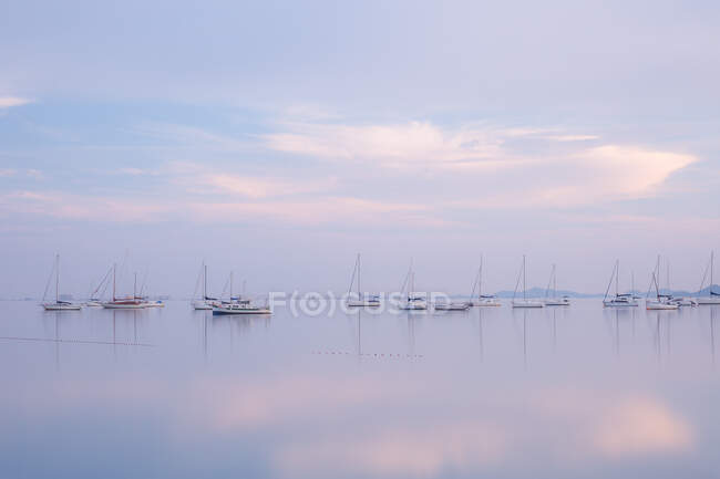 Boats on calm sea water in evening — Stock Photo