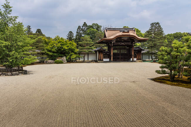 Vue imprenable sur un terrain sablonneux plat et merveilleuse porte traditionnelle dans le majestueux parc zen au Japon — Photo de stock
