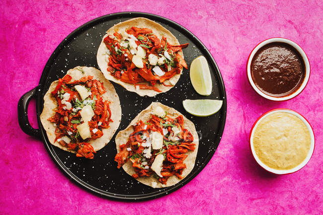 Pepper and lime near tacos al pastor and sauces — Stock Photo