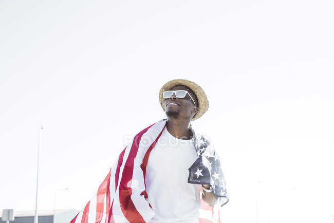 Cheerful black man with American flag — Stock Photo