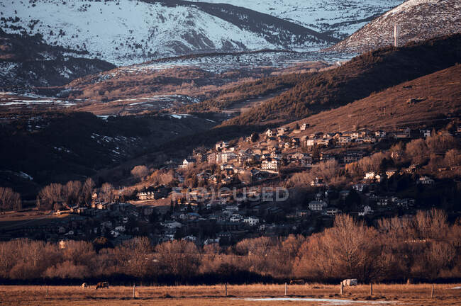 Panorama pittoresco del villaggio di campagna tra le montagne con foresta nella neve a Cerdanya, Francia — Foto stock