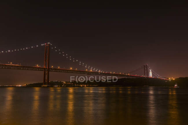 View to river and big illuminated Golden Gate bridge at night in San Francisco, California, USA — Stock Photo