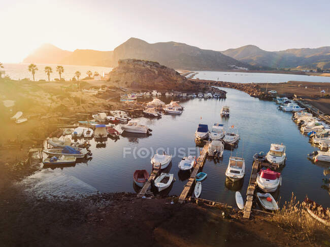 View to different size motorboats moored at quails in small dock at seaside — Stock Photo