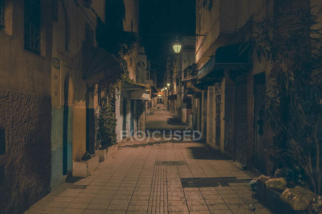 Vista incrível da rua pobre entre casas antigas à noite em Marraquexe, Marrocos — Fotografia de Stock
